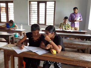 Scribe assistance for a Divyangjan candidate during a University examination.